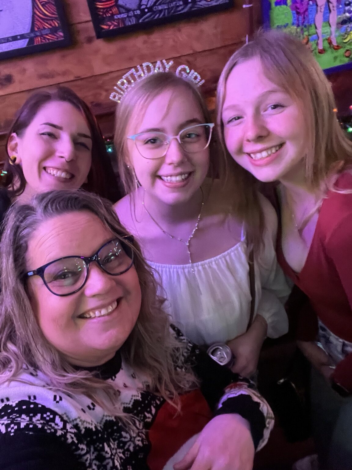 Four friends smiling together at Vinnie's