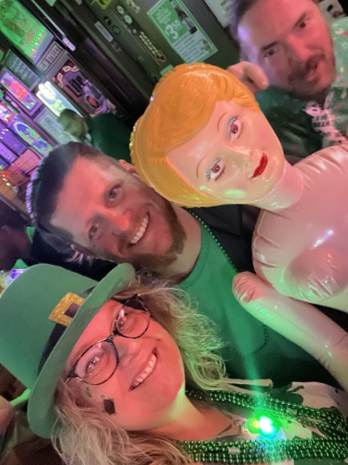 Friends posing with a mannequin at the bar